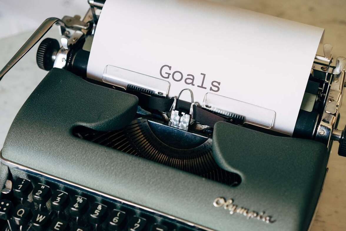 The word "Goals" typed on paper in a typewriter