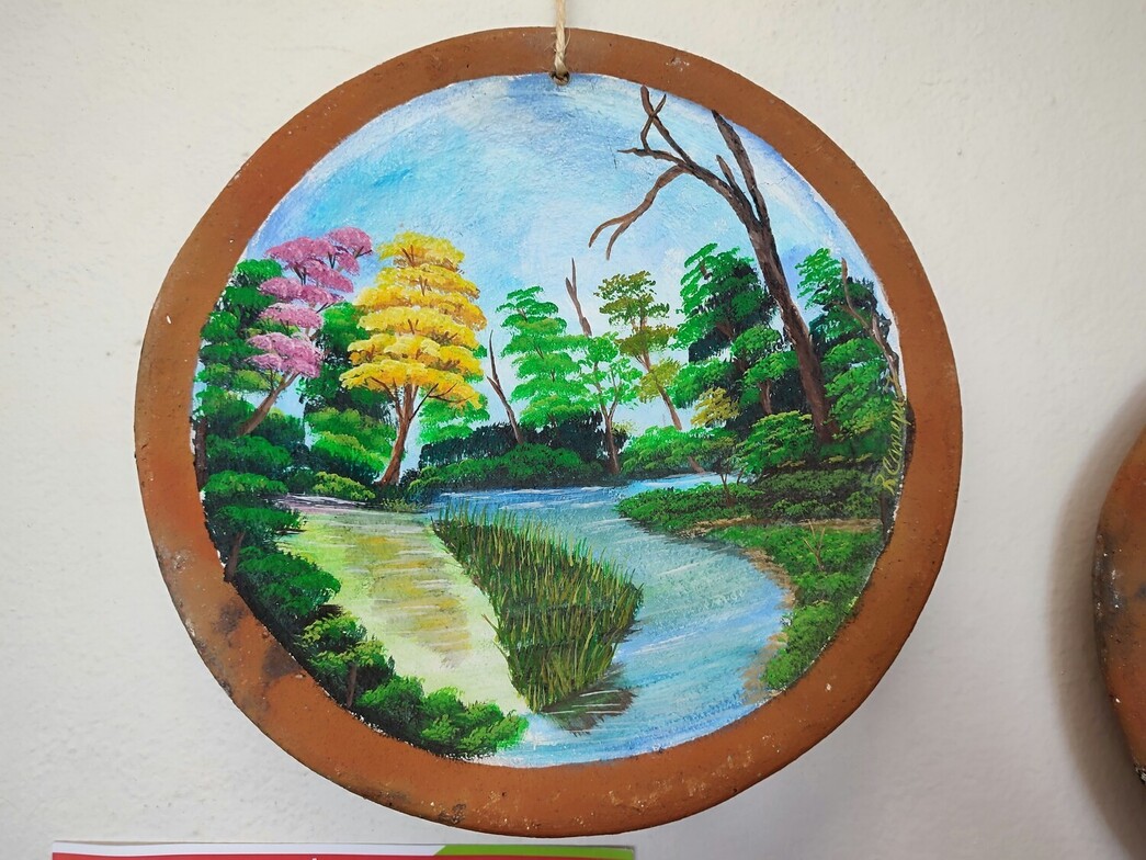 Hand-painted wooden disk featuring a summer memory, used as a reflective practice to connect with personal meaning.