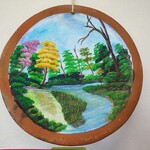 Hand-painted wooden disk featuring a summer memory, used as a reflective practice to connect with personal meaning.